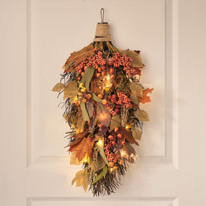 Pre-lit maple orchard autumn bough with foliage and warm white lights