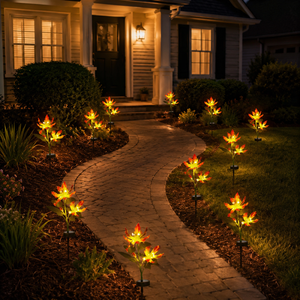 Solar flame lily lights following a curved front walkway at night