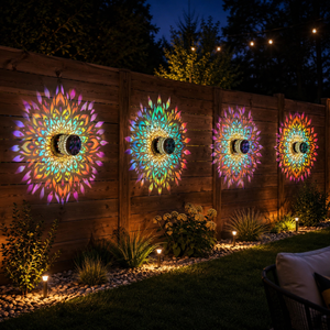 solar mandala light projecting colorful pattern on patio wall and garden fence at night