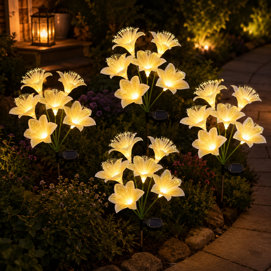 Six-head lily flower solar stakes glowing along a garden path at night