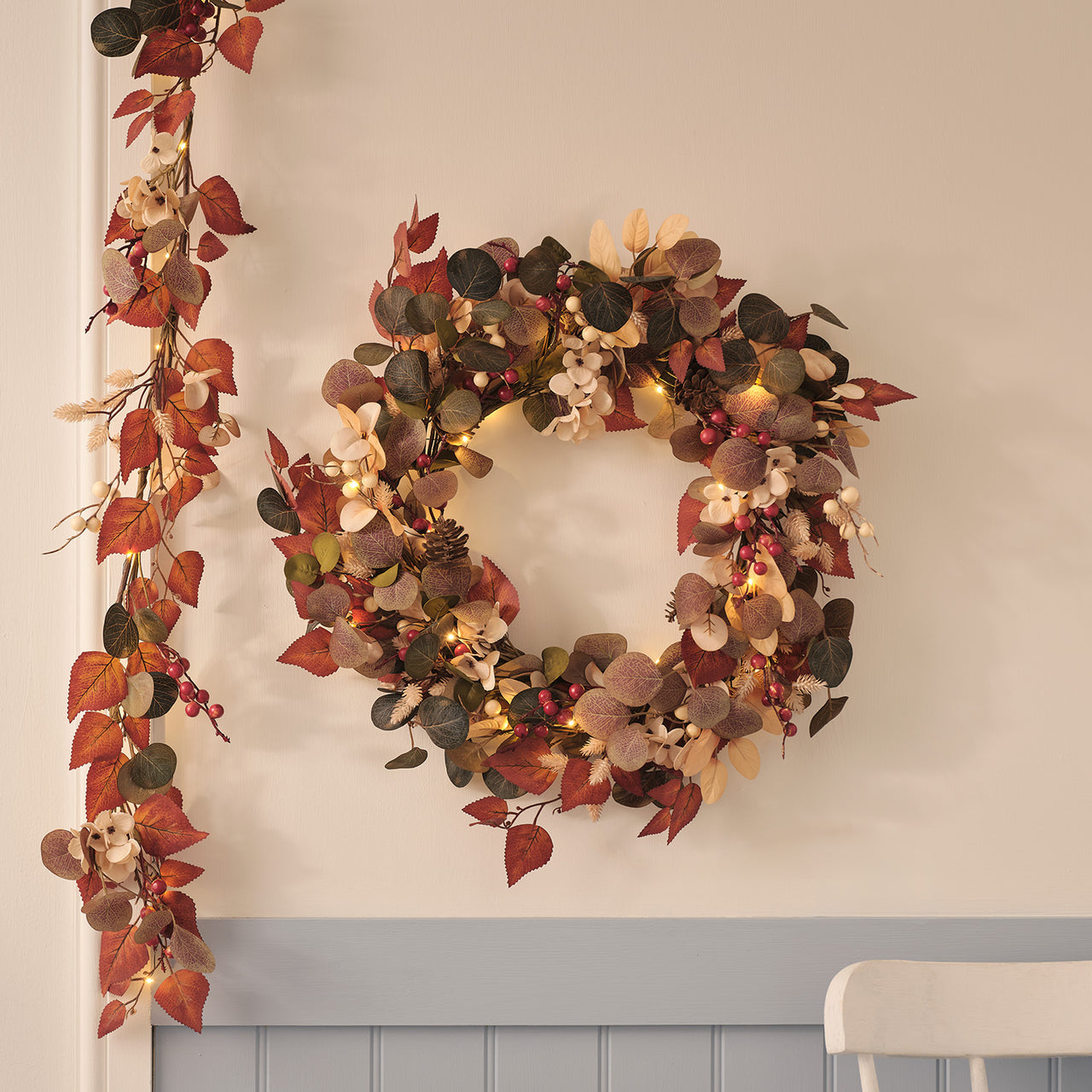 Pre-lit berry harvest wreath and autumn foliage garland with warm white lights