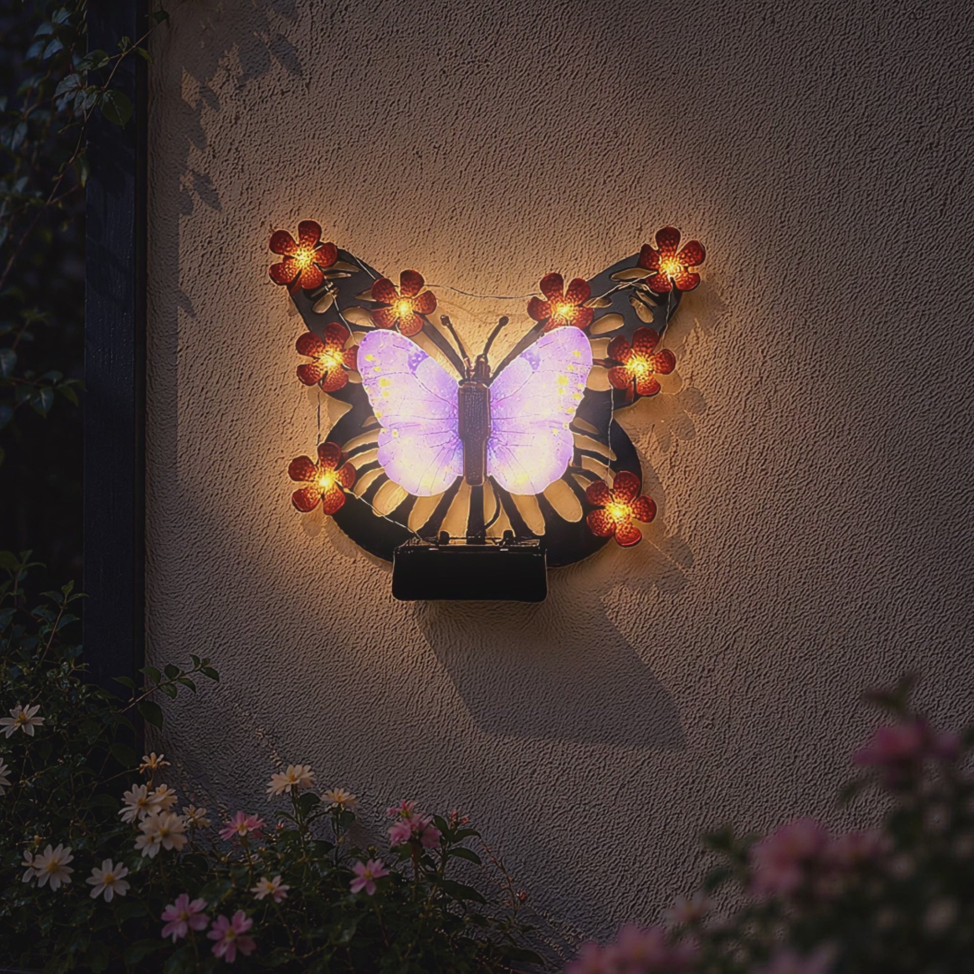 solar butterfly wall light glowing on garden fence patio wall and porch decor