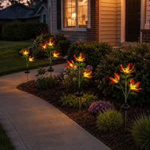 Solar flame lily lights warming a front entry garden after dark